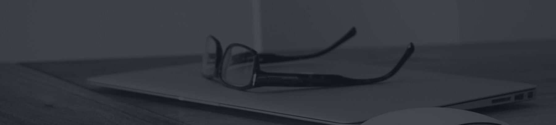 Glasses on a closed laptop