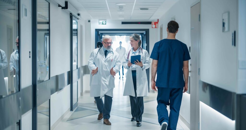 Doctors and medical staff walking through a hospital hallway, representing medical care and treatment after an injury or accident.