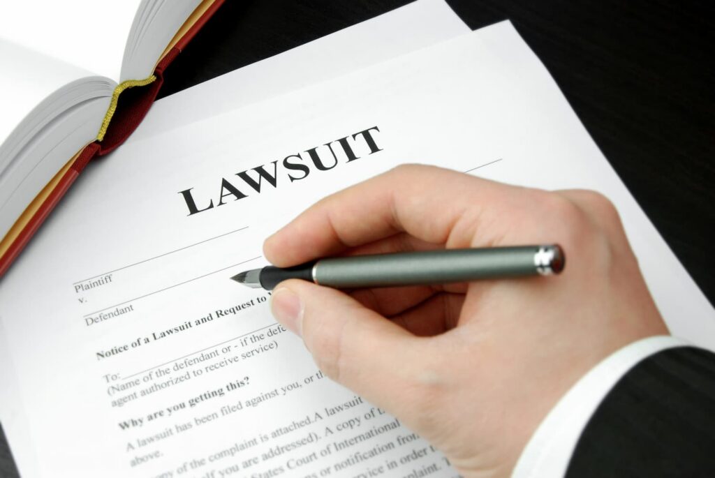 Signing a personal injury lawsuit document after insurance claim denial in Texas