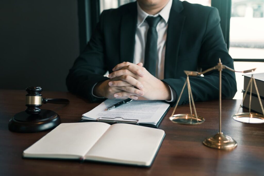 Fort Worth construction accident lawyer reviewing case documents at desk with legal scales and gavel