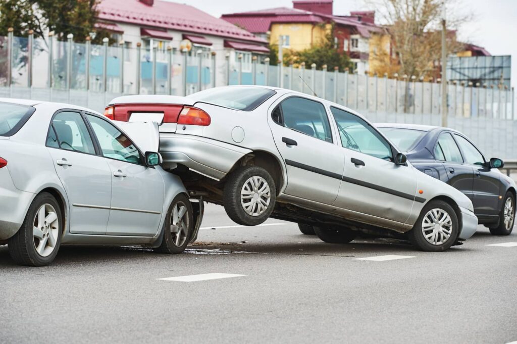 Chain Reaction Car Accident Liability in Multi-Vehicle Crash Three-car rear-end collision showing chain reaction crash damage and liability scenario on urban roadway