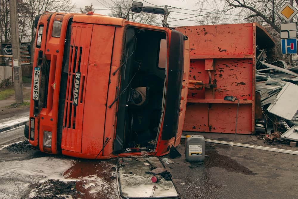Overturned orange truck following a roadway crash