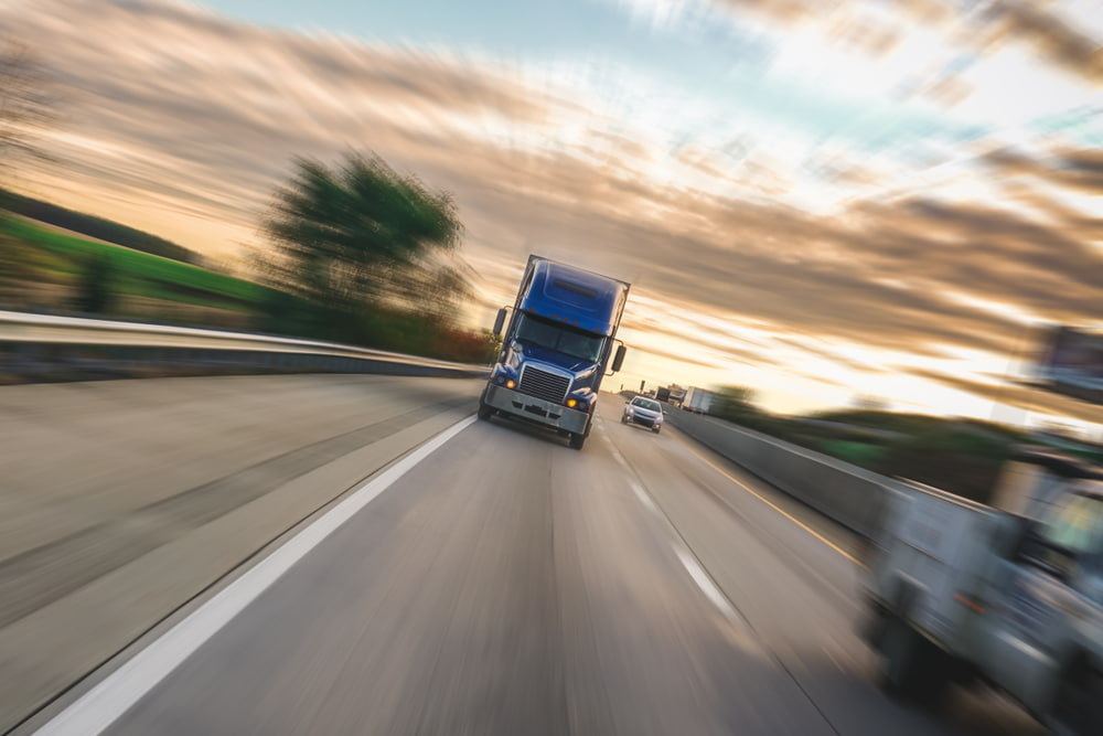 Semi-truck traveling at highway speed on an interstate roadway